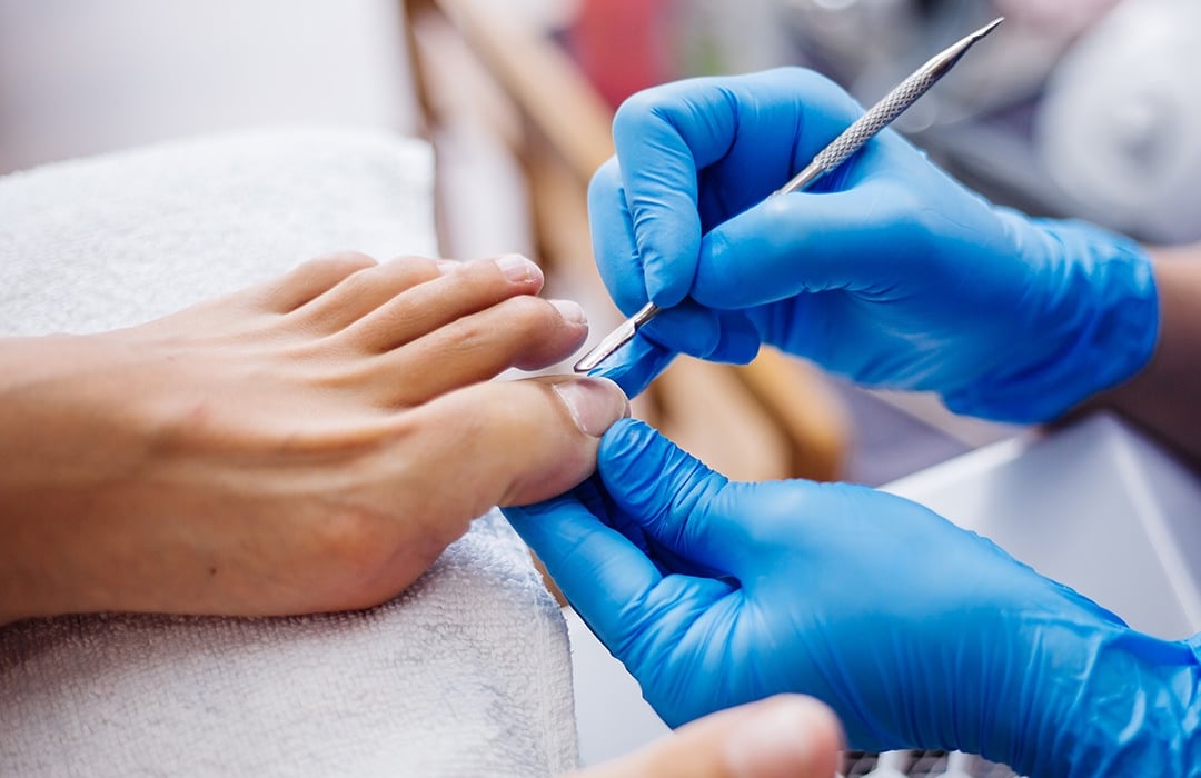 A clinician providing foot care during a visit